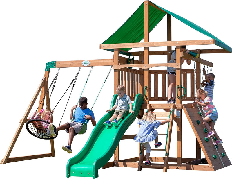 A complete set of wooden mountain-style swings, equipped with a colorful canvas sunshade, a wave slide, a rope swing, a net swing, and a rock wall with climbing ropes and ladders. E3029